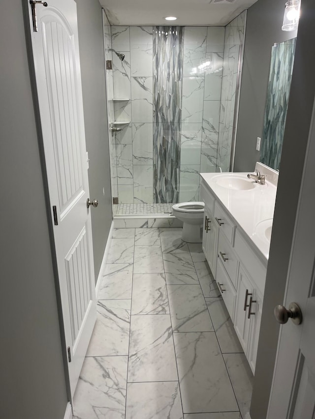 bathroom featuring tiled shower, toilet, tile patterned floors, and dual vanity