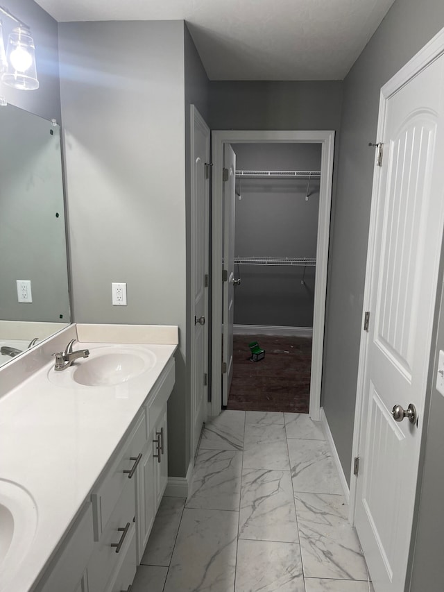 bathroom with dual vanity and tile patterned floors