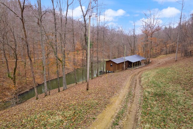 exterior space featuring an outbuilding and a water view