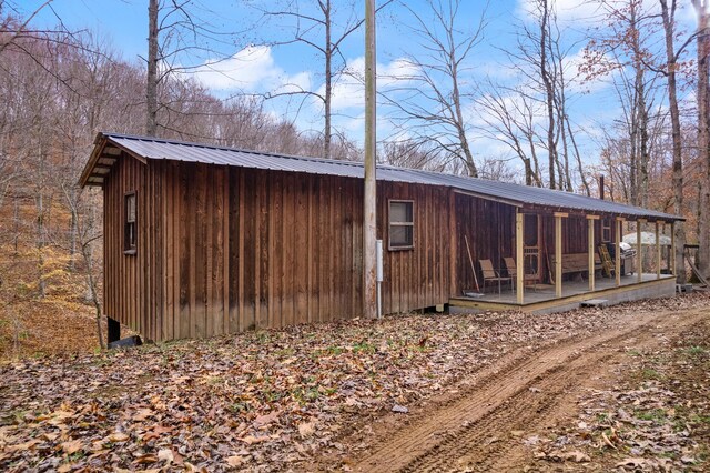 rear view of house with an outdoor structure