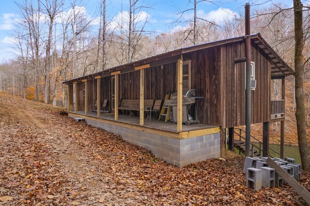 view of property exterior with a wooden deck