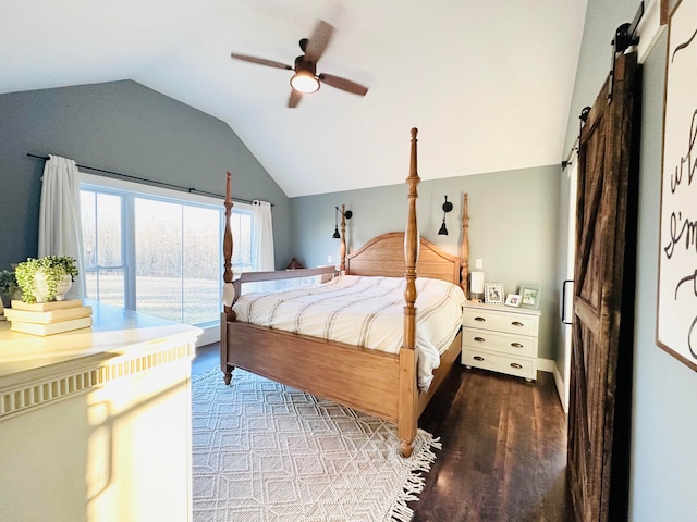 bedroom with lofted ceiling, a barn door, ceiling fan, and hardwood / wood-style flooring