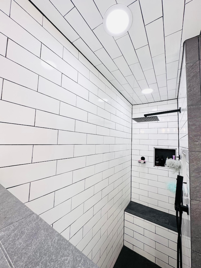 bathroom with a tile shower