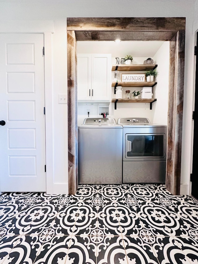 laundry room featuring cabinets and washer and dryer