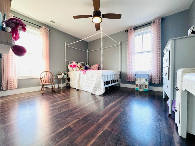 bedroom with ceiling fan and dark hardwood / wood-style floors