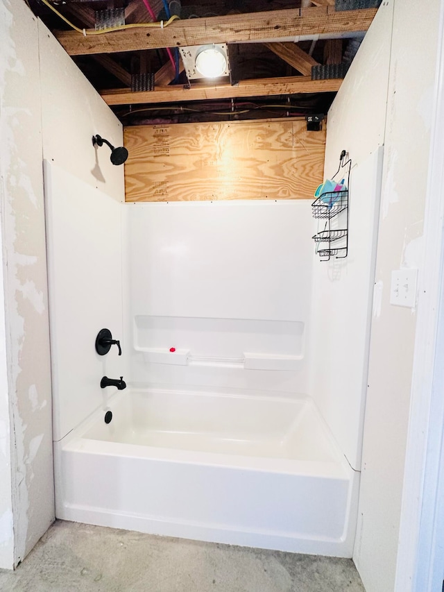 bathroom featuring shower / bathing tub combination and concrete floors