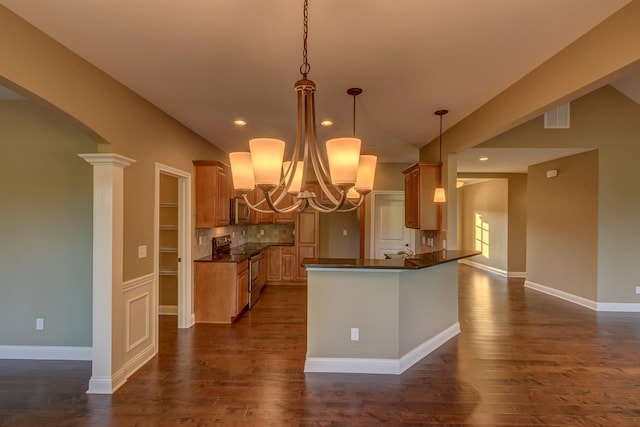 kitchen with hanging light fixtures, kitchen peninsula, dark hardwood / wood-style flooring, and stainless steel electric range oven