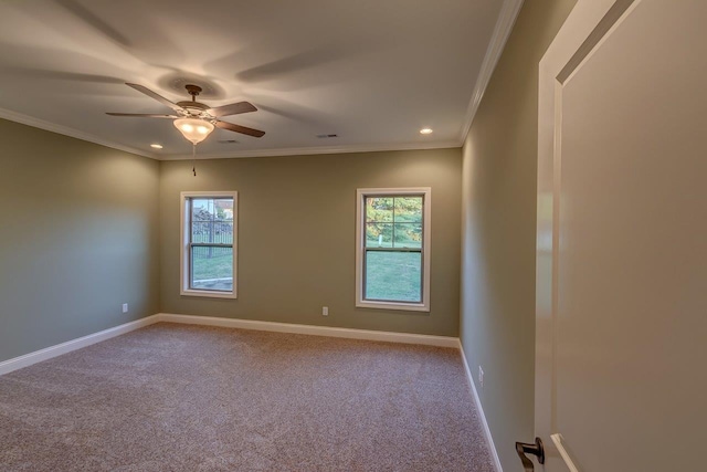 carpeted spare room with ceiling fan, crown molding, and a wealth of natural light