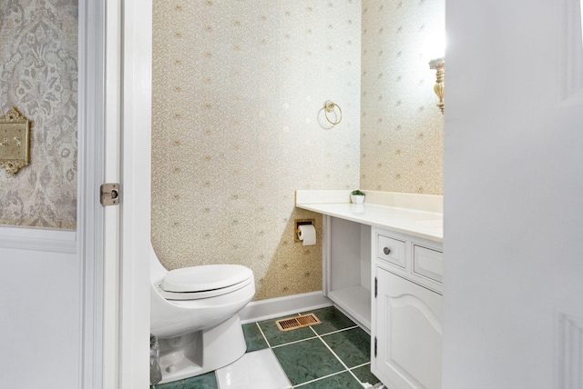 bathroom featuring tile floors, toilet, and vanity