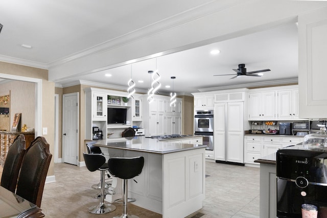 kitchen featuring ceiling fan, stainless steel appliances, white cabinetry, and light tile flooring