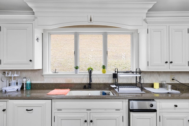 kitchen featuring white cabinets, sink, tasteful backsplash, and plenty of natural light