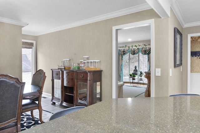 dining room with ornamental molding, a healthy amount of sunlight, and light tile floors