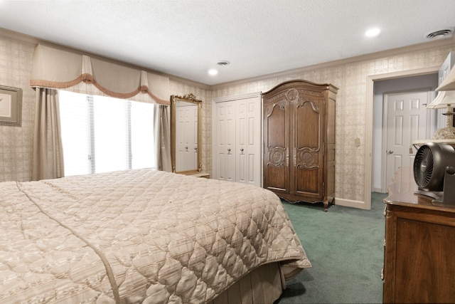 bedroom featuring a textured ceiling and dark carpet