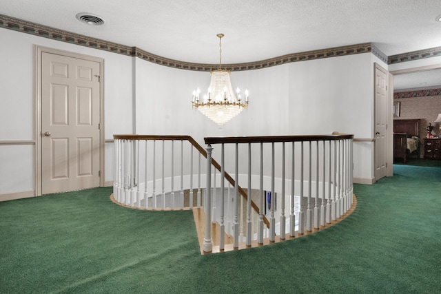 hallway featuring a textured ceiling, carpet flooring, and a notable chandelier