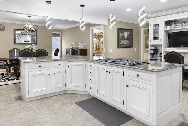 kitchen with pendant lighting, light tile floors, crown molding, stainless steel gas stovetop, and white cabinetry