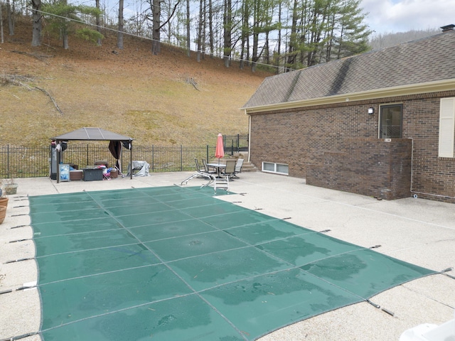 view of swimming pool featuring a gazebo and a patio