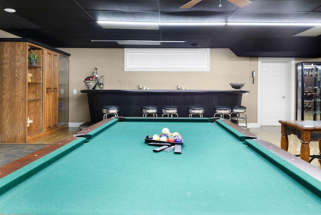 recreation room featuring bar, billiards, a drop ceiling, and hardwood / wood-style flooring