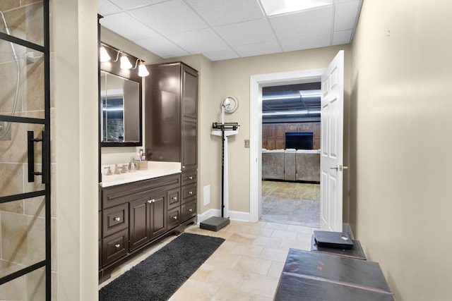 bathroom featuring vanity, tile floors, and a drop ceiling