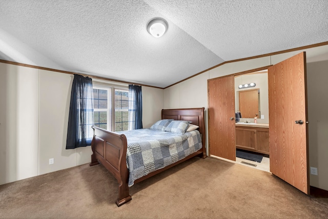 bedroom featuring connected bathroom, a textured ceiling, light colored carpet, and vaulted ceiling