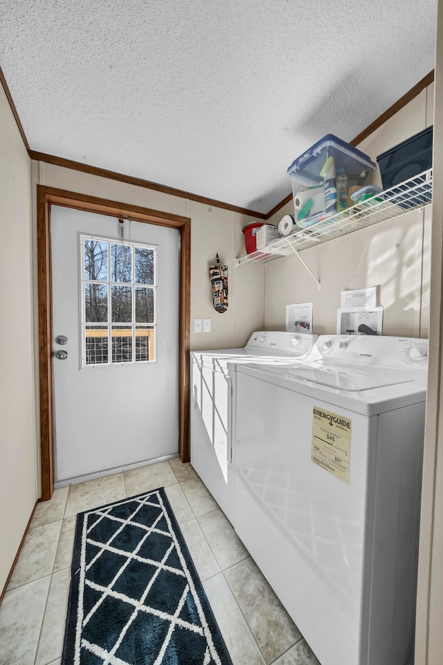 washroom with washing machine and clothes dryer, crown molding, hookup for a washing machine, and a textured ceiling