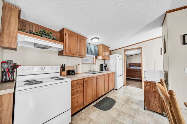 kitchen featuring sink, white appliances, and a textured ceiling