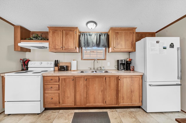 kitchen featuring white appliances, a textured ceiling, crown molding, and sink