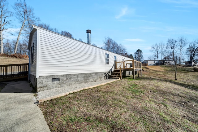 view of property exterior with a wooden deck and a lawn