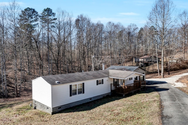 view of side of home featuring a wooden deck