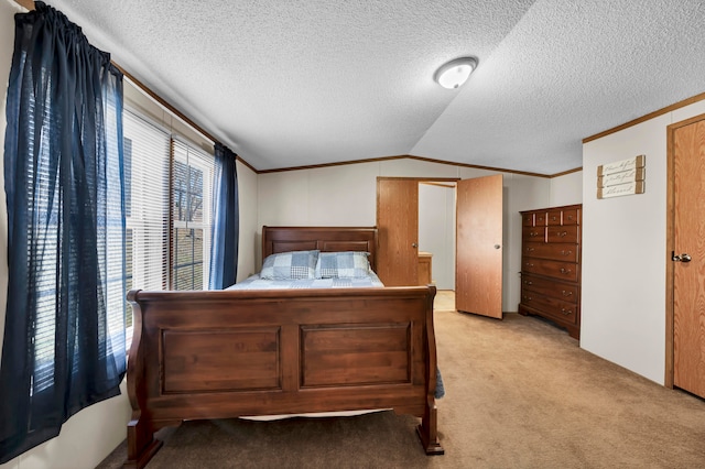 bedroom featuring a textured ceiling, vaulted ceiling, and light colored carpet