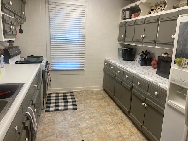 kitchen featuring light tile flooring and range