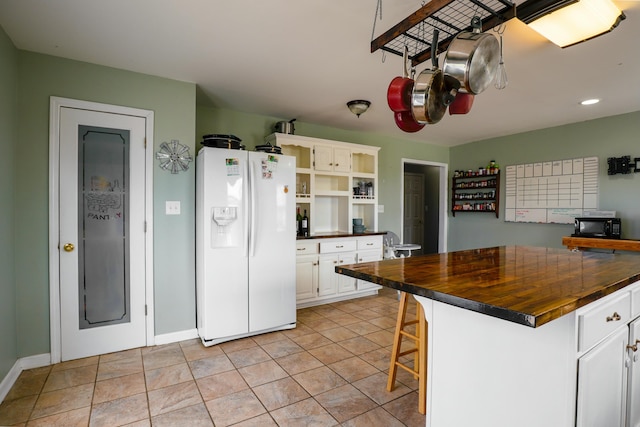 427 Sharpsburg Rd, Sharpsburg, KY 40374 - kitchen featuring white cabinetry, open shelves, butcher block countertops, white fridge with ice dispenser, and black microwave