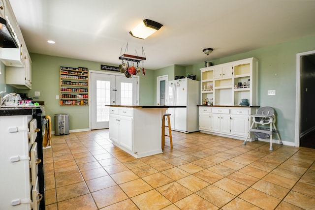 427 Sharpsburg Rd, Sharpsburg, KY 40374 - kitchen with dark countertops, open shelves, white cabinetry, and freestanding refrigerator