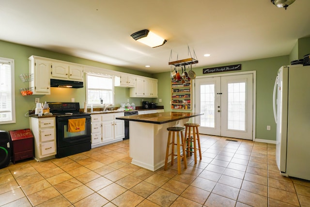 427 Sharpsburg Rd, Sharpsburg, KY 40374 - kitchen featuring white cabinets, black / electric stove, under cabinet range hood, a sink, and freestanding refrigerator