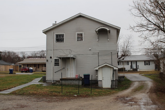 rear view of house featuring a lawn