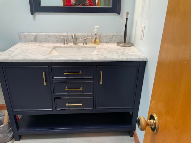 bathroom featuring tile floors and vanity