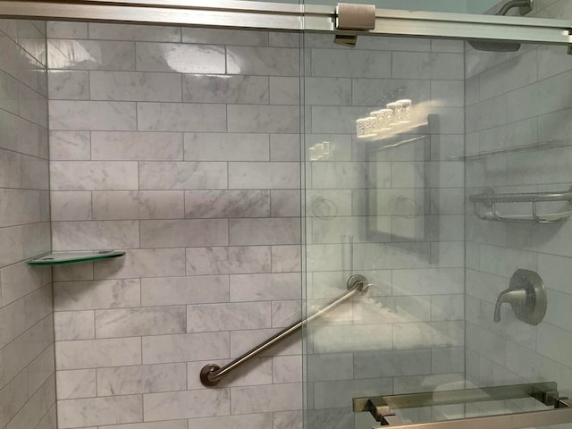 bathroom with a shower with door