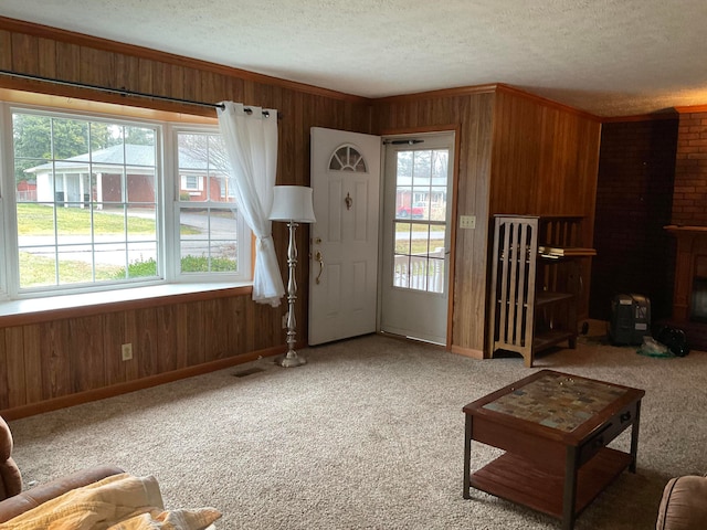 unfurnished living room with light carpet, plenty of natural light, and a textured ceiling