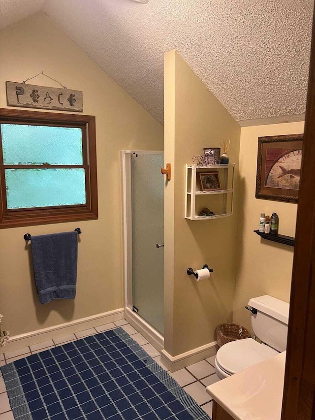 bathroom with a textured ceiling, tile flooring, and lofted ceiling