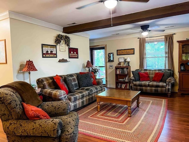 living room featuring dark hardwood / wood-style flooring, ceiling fan, ornamental molding, and beam ceiling