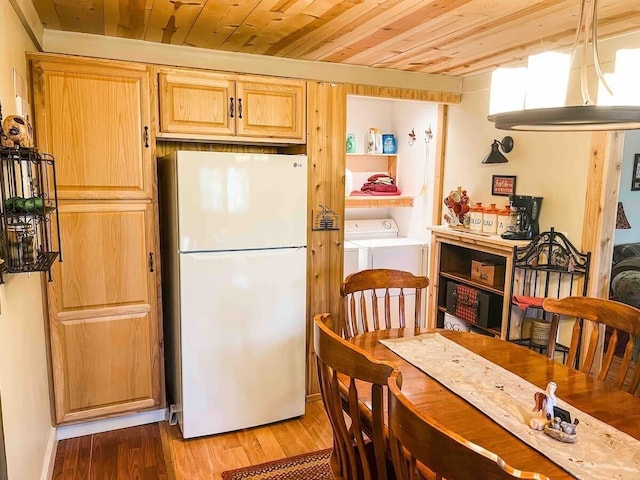 kitchen featuring light hardwood / wood-style floors, white fridge, wood ceiling, washing machine and clothes dryer, and hanging light fixtures