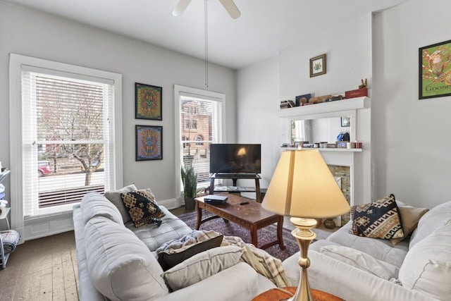 living room with plenty of natural light, wood-type flooring, and ceiling fan