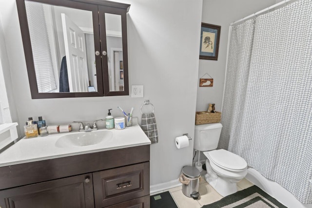 bathroom with tile flooring, vanity, and toilet