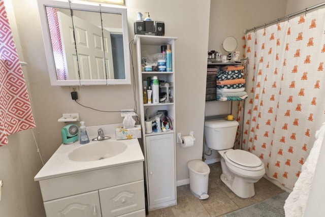 bathroom featuring toilet, tile floors, and large vanity