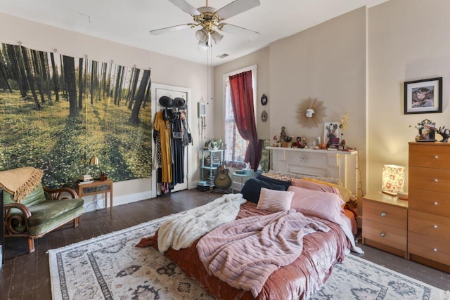 bedroom featuring a closet, wood-type flooring, and ceiling fan