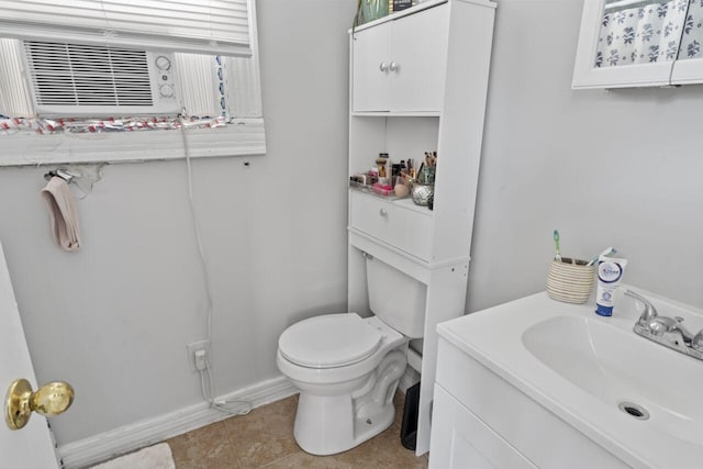 bathroom with tile flooring, toilet, and vanity