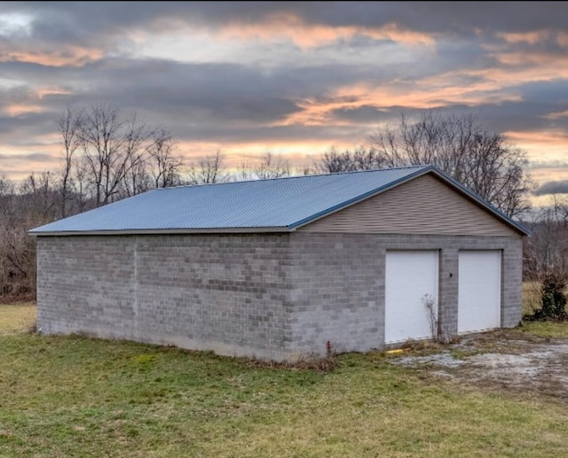 garage at dusk with a yard