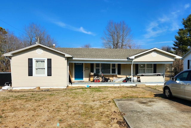 ranch-style house with a front lawn and covered porch