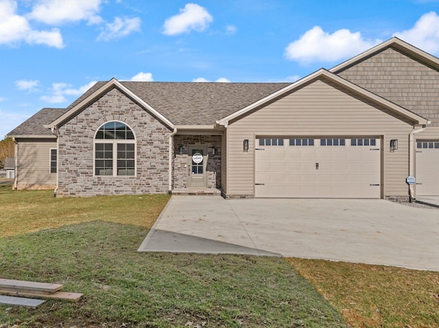 view of front of property featuring a garage and a front yard