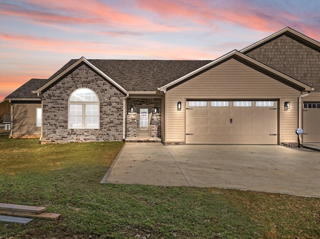 view of front facade with a garage and a lawn