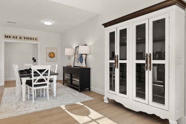 dining area with light hardwood / wood-style floors